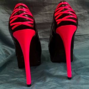 Pink and black spiked heels